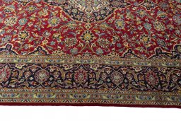 Corner detail of 2000s Kashan rug showing border pattern and Cork pile