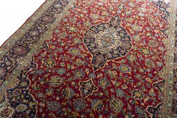 Backside of handmade 2000s Kashan rug showing knot structure and weave density