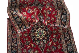 Corner detail of 2000s Kashan rug showing border pattern and Wool pile