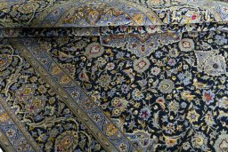 Corner detail of New Kashan rug showing border pattern and Cork pile