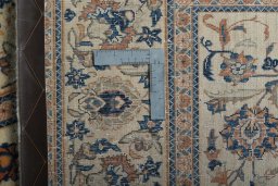 Backside of handmade 1970s Kashan rug showing knot structure and weave density