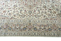 Corner detail of 2000s Kashan rug showing border pattern and Wool pile