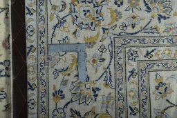 Backside of handmade New Kashan rug showing knot structure and weave density