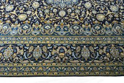 Corner detail of 2000s Kashan rug showing border pattern and Wool pile