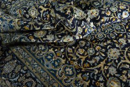 Surface texture of 2000s Kashan rug with natural Wool and intricate pattern