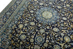 Backside of handmade 2000s Kashan rug showing knot structure and weave density