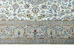Corner detail of 2000s Kashan rug showing border pattern and Wool pile