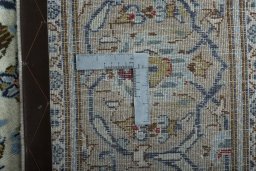 Backside of handmade 2000s Kashan rug showing knot structure and weave density
