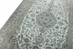 Backside of handmade 2000s Kashan rug showing knot structure and weave density