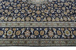 Corner detail of 2000s Kashan rug showing border pattern and Wool pile