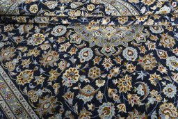 Close-up detail of 2000s Kashan rug from Iran / Persia showing Wool weave