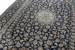 Backside of handmade 2000s Kashan rug showing knot structure and weave density
