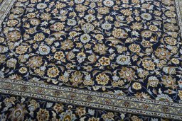 Close-up detail of 2000s Kashan rug from Iran / Persia showing Wool weave