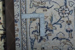 Backside of handmade 2000s Kashan rug showing knot structure and weave density