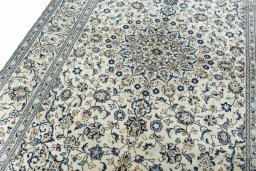 Backside of handmade 2000s Kashan rug showing knot structure and weave density