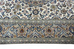 Corner detail of 2000s Kashan rug showing border pattern and Wool pile