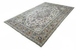 Corner detail of 2000s Kashan rug showing border pattern and Wool pile