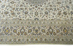 Corner detail of 2000s Kashan rug showing border pattern and Wool pile