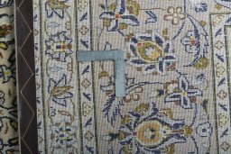 Backside of handmade 2000s Kashan rug showing knot structure and weave density