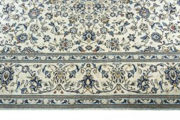 Corner detail of 2000s Kashan rug showing border pattern and Wool pile