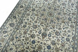Backside of handmade 2000s Kashan rug showing knot structure and weave density