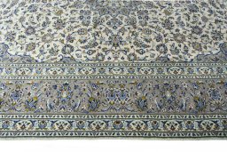 Corner detail of 2000s Kashan rug showing border pattern and Wool pile