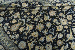 Corner detail of 2000s Kashan rug showing border pattern and Wool pile