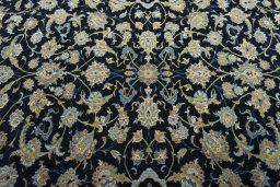 Backside of handmade 2000s Kashan rug showing knot structure and weave density