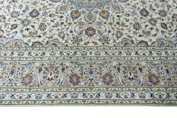 Corner detail of 2000s Kashan rug showing border pattern and Wool pile