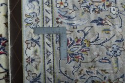 Backside of handmade 2000s Kashan rug showing knot structure and weave density