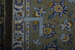 Backside of handmade 2000s Kashan rug showing knot structure and weave density