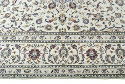 Corner detail of 2000s Kashan rug showing border pattern and Wool pile