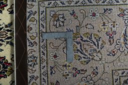 Backside of handmade New Kashan rug showing knot structure and weave density