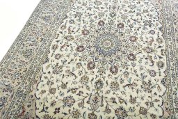 Backside of handmade New Kashan rug showing knot structure and weave density