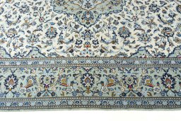 Corner detail of 2000s Kashan rug showing border pattern and Wool pile