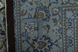 Backside of handmade 2000s Kashan rug showing knot structure and weave density