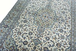 Backside of handmade 2000s Kashan rug showing knot structure and weave density