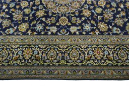 Corner detail of 2000s Kashan rug showing border pattern and Wool pile