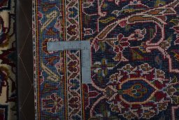 Backside of handmade 2000s Kashan rug showing knot structure and weave density