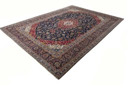 Corner detail of 2000s Kashan rug showing border pattern and Wool pile