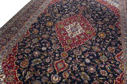 Backside of handmade 2000s Kashan rug showing knot structure and weave density
