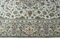 Corner detail of 2000s Kashan rug showing border pattern and Wool pile