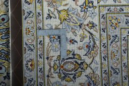 Backside of handmade New Kashan rug showing knot structure and weave density