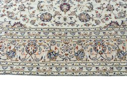 Corner detail of 2000s Kashan rug showing border pattern and Wool pile