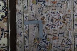 Backside of handmade 2000s Kashan rug showing knot structure and weave density