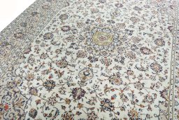 Backside of handmade 2000s Kashan rug showing knot structure and weave density