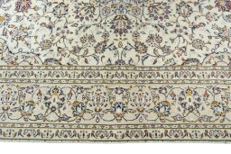 Corner detail of 2000s Kashan rug showing border pattern and Wool pile