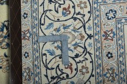 Backside of handmade 2000s Kashan rug showing knot structure and weave density
