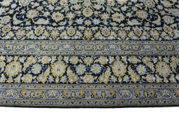 Corner detail of 2000s Kashan rug showing border pattern and Wool pile