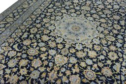 Backside of handmade 2000s Kashan rug showing knot structure and weave density
